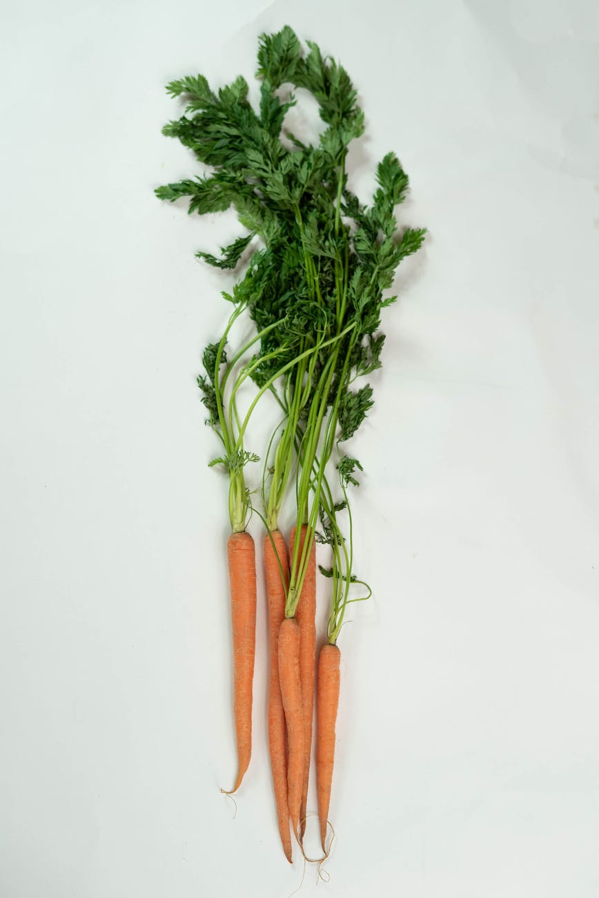 bunch of carrots on white table